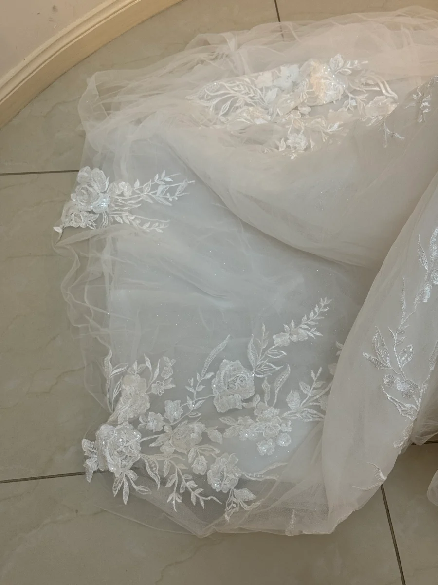 Wedding dress before cleaning with visible dirt and stains