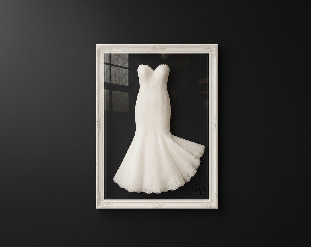 "Elegant strapless mermaid wedding dress framed in white ornate shadow box against a matte black wall, showcasing professional bridal gown preservation and display by Bridal Dry Cleaning Experts in Sydney.