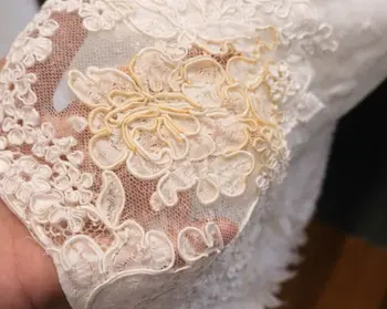 Champagne spill stain on white bridal fabric before sugar-dissolving treatment