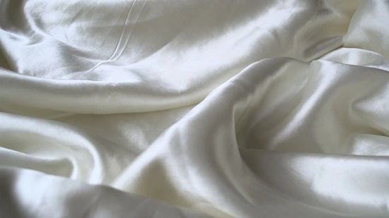 Close-up of bridal silk fabric showing smooth lustre and tight weave