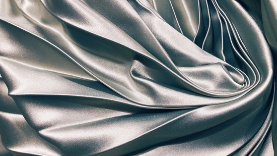 Close-up of bridal taffeta fabric showing structured ribbed weave with sheen