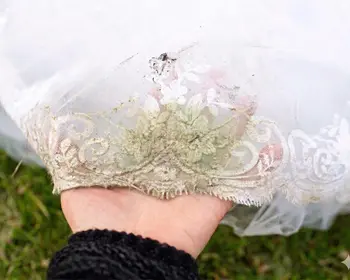 Grass stain on white wedding dress train before chlorophyll solvent treatment